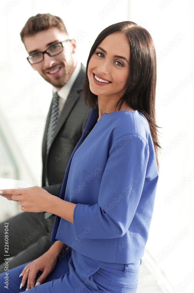 cheerful business couple looking at file indoors. cheerful business couple looking at file indoors.