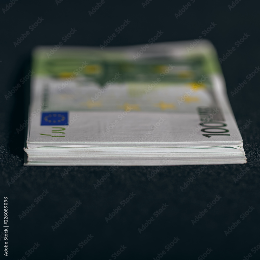 European euro currency bank notes lying on a desk close-up, symbolizing finance and business.. European euro currency bank notes lying on a desk close-up, symbolizing finance and business..