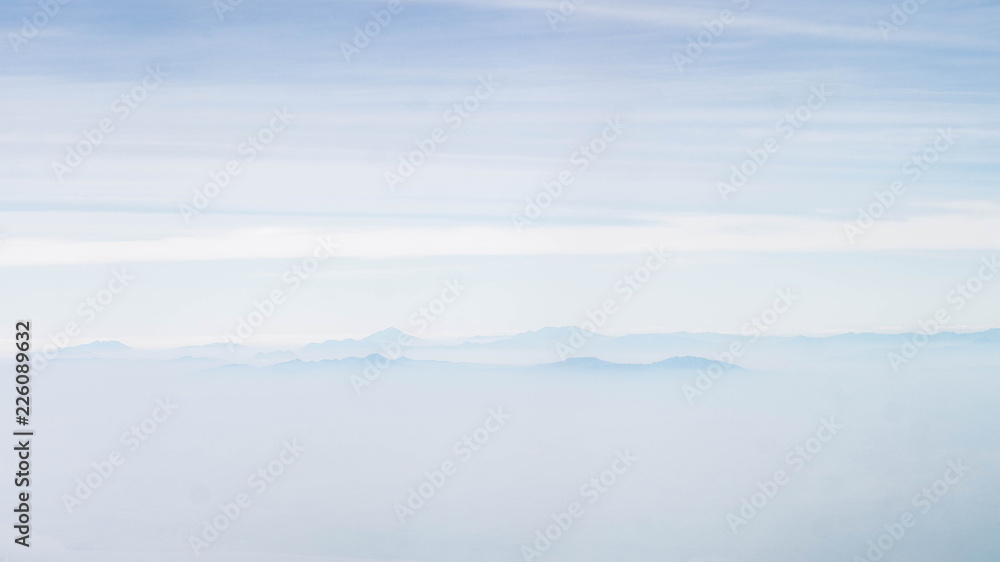 mountains among the cloud. panorama of mountain peaks covered by cloud. nature background