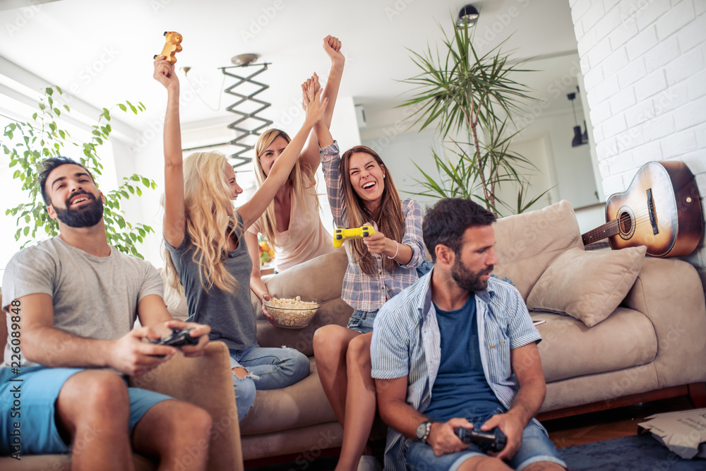 Excited friends playing video games at home Excited friends playing video games at home