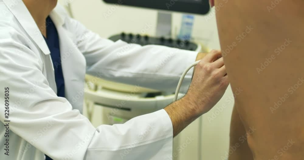 A doctor uses a modern sonogram to view vein in sclerotherapy procedure. An innovative method of varicose veins surgery, close-up