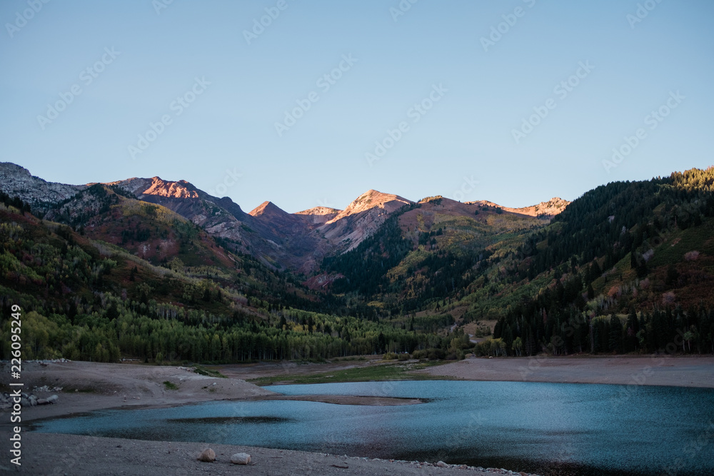 Mountain Peaks Lit by a Sunset about a Alpine Lake in Utah
