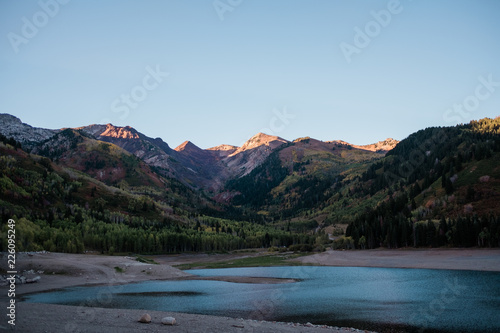 Mountain Peaks Lit by a Sunset about a Alpine Lake in Utah