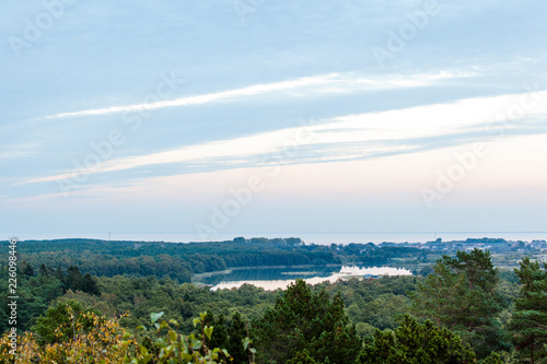 twilight during the blue hour over the forest and the small lake