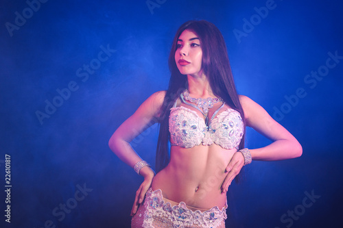 Canvas-taulu Woman in exotic costume sexually moves semi-nude body