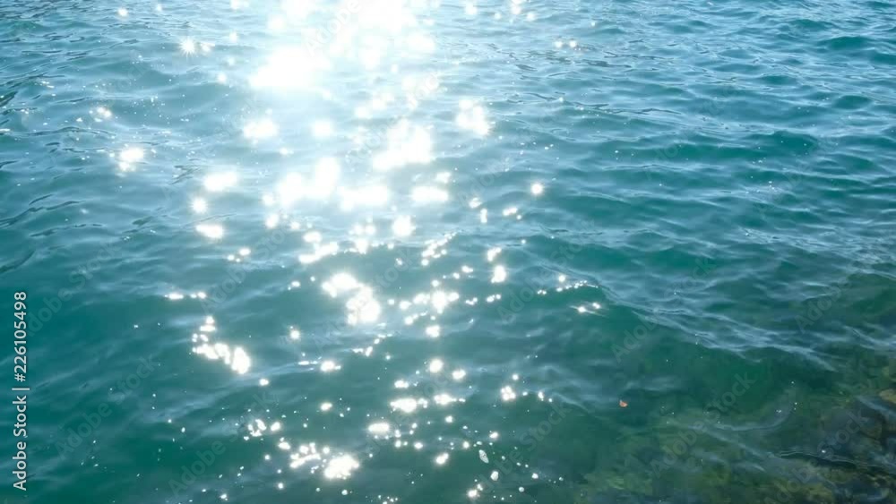 wavy water surface with a beautiful bokeh of sun glares. wavy water surface with a beautiful bokeh of sun glares.
