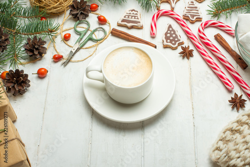 Christmas, New Year background. Flat-lay, glittering toys, mug hot latte, cookies, pine cone above the wooden table, top view, copy space. The banner