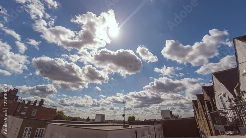 Timelapse of clouds crossing a summer sky, viewed from a urban flat in London