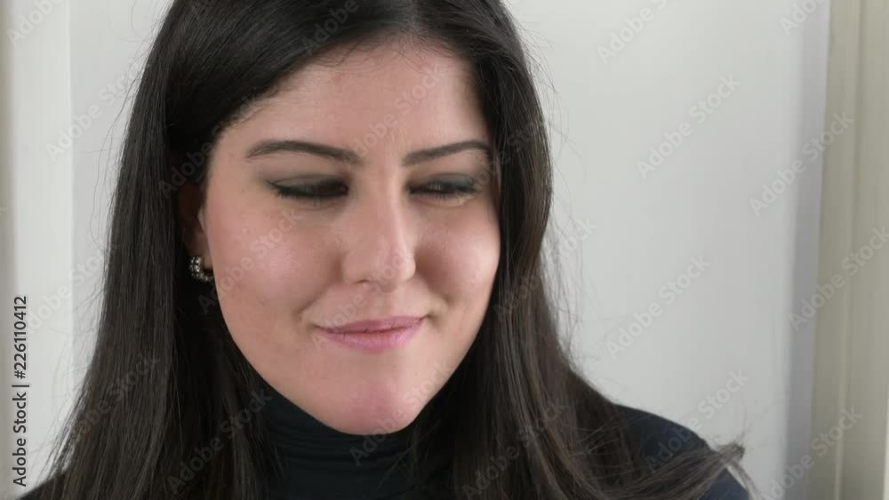 close up portrait of Beautiful young brunette laughig at camera- indoor close up portrait of Beautiful young brunette laughig at camera- indoor