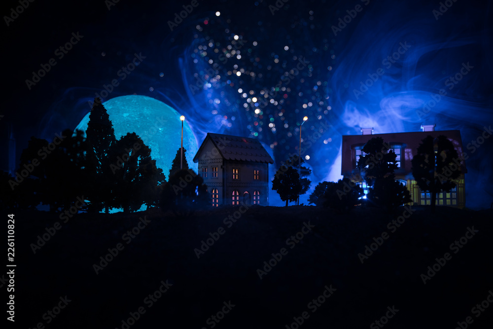 Little decorative houses, beautiful festive still life, cute small houses at night, pine trees glowing lights, happy winter holidays