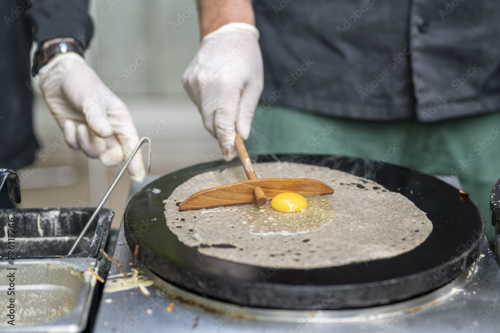 Cooking a salty crepe with ham, egg and cheese, a nice hand made ...