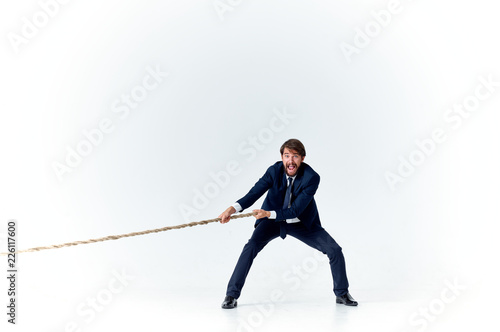 man pulls the rope on an isolated background
