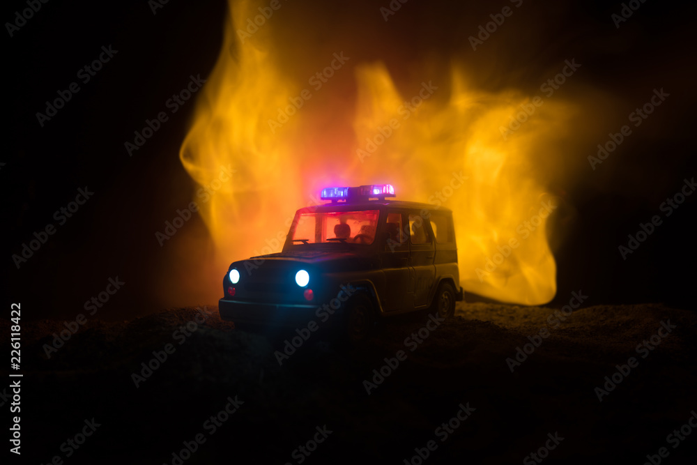Police car chasing a car at night with fog background. 911 Emergency response police car speeding to scene of crime. Police car chasing a car at night with fog background. 911 Emergency response police car speeding to scene of crime.