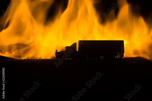 Big truck wagon rides on the road outside the city at night with foggy background. Decoration