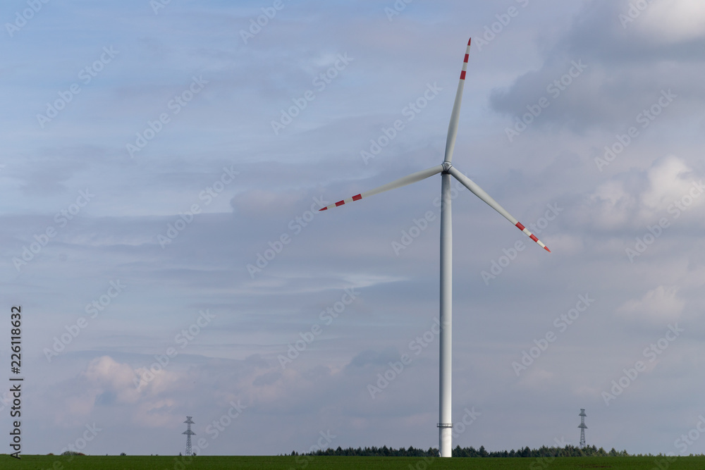 Wind farm on an open field. A windmill that generates electricity in central europe. Wind farm on an open field. A windmill that generates electricity in central europe.