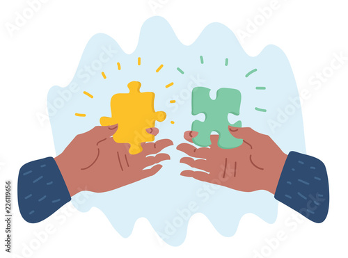 Hands putting puzzle pieces.