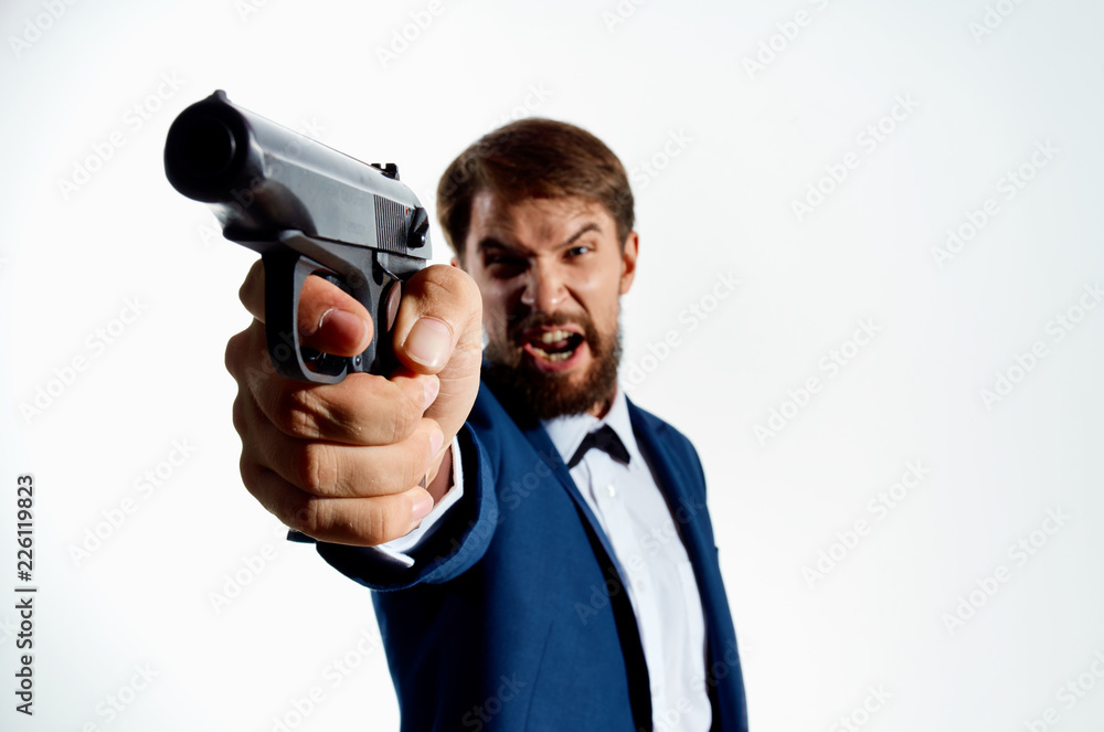 angry beard man screaming shoots with weapons