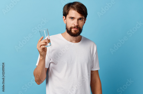 man in white t-shirt holding a glass of water © SHOTPRIME STUDIO