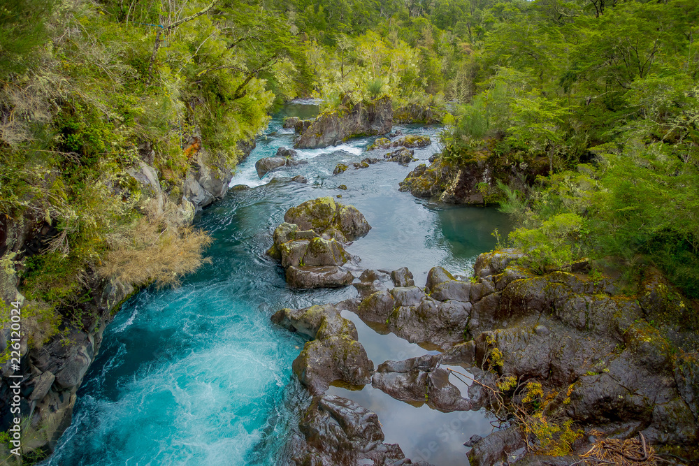 Gorgeous view of water passing through volcanic rock creating waterfalls, formed by an eruption of volcano Osorno in the south of Chile Gorgeous view of water passing through volcanic rock creating waterfalls, formed by an eruption of volcano Osorno in the south of Chile