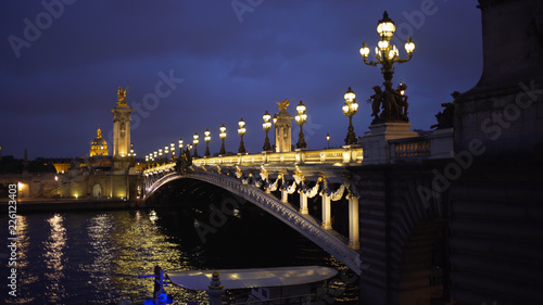 Beautiful view of night lights on Alexandre III bridge across the Seine in Paris