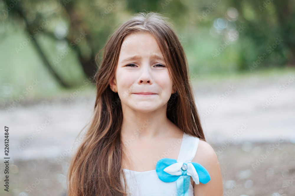 little girl with long hair portrait, emotionally crying and upset ...