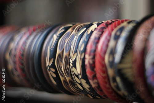 Lined up colorful traditional braceled made from wood showed on rack, Yogyakarta, Indonesia