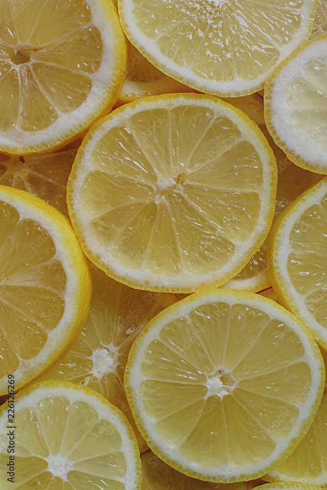 Fresh organic ripe lemons, lemon slices, top view Fresh organic ripe lemons, lemon slices, top view