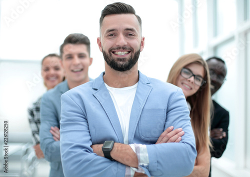 Obraz na plátně Confident business team standing and smiling with folded arms