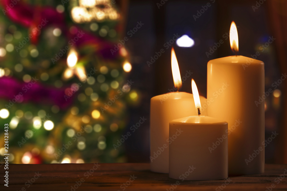 Burned candles with blurred Christmas tree Burned candles with blurred Christmas tree