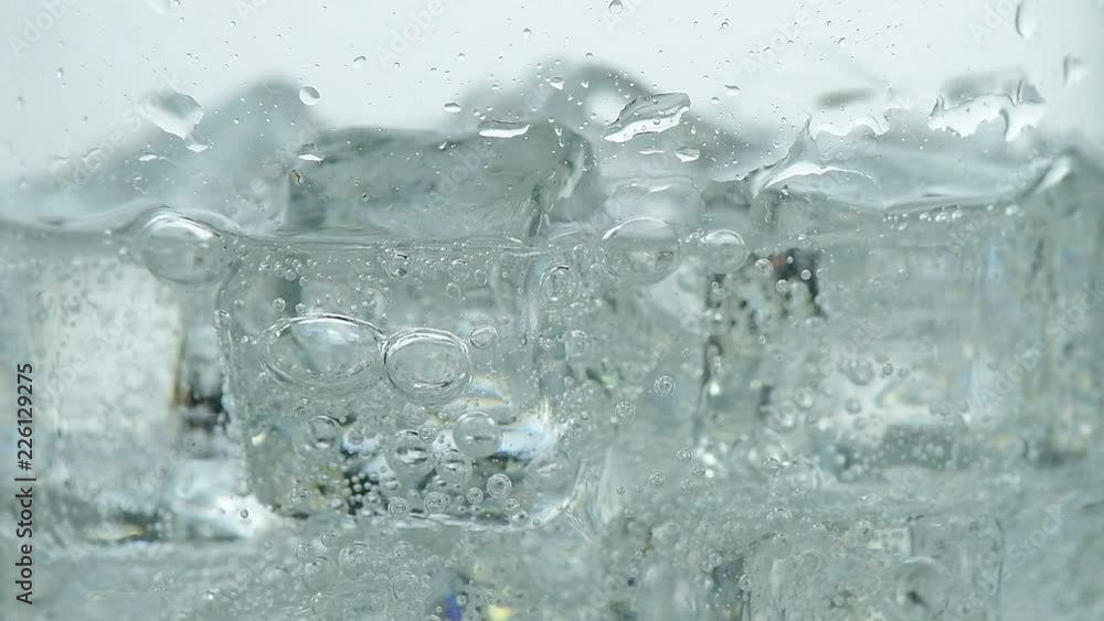 Pouring soda water with ice and bubbles in the glass Pouring soda water with ice and bubbles in the glass