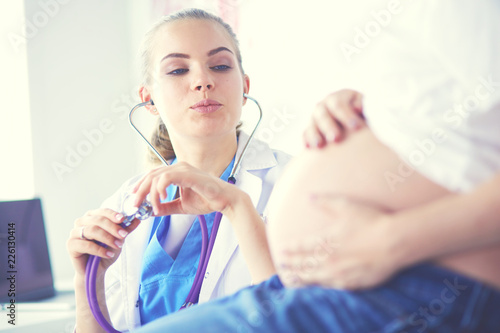 Young female doctor examining pregnant woman at the clinic.