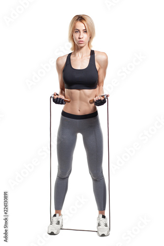 sporty woman with skipping rope isolated on white background