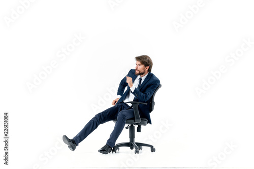 business man sitting on a chair talks