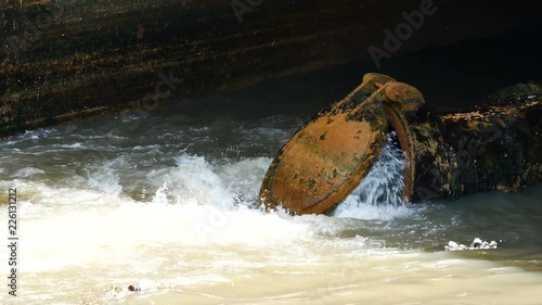 Wallpaper Mural Environmental Video After a heavy rain the sewer system of the big city is draining through wastewater treatment into the canal through the drain door to prevent flooding and Environmental protection. Torontodigital.ca