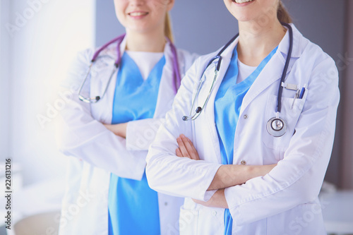 Cropped shoot of two young doctors female with stethoscope.