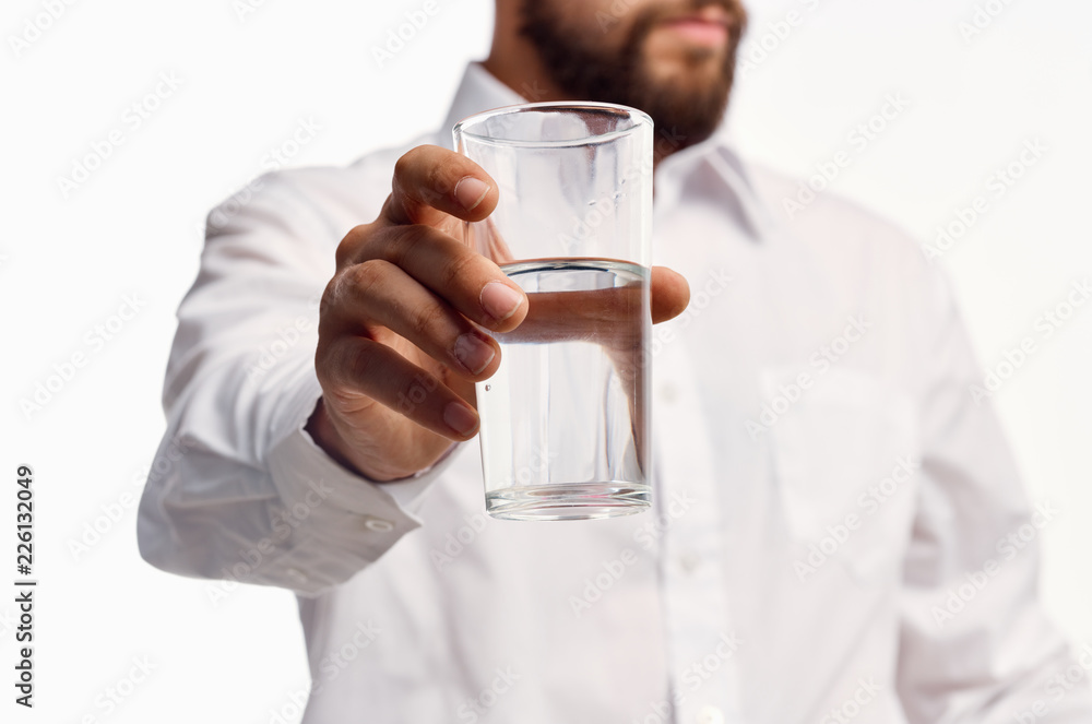 man holding a glass of water man holding a glass of water