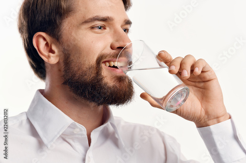 man drinks water from a glass