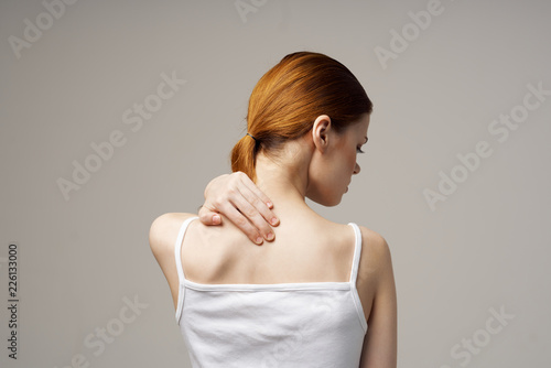 a young woman has a sore neck