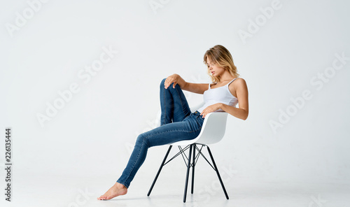 blonde sits on white glass on an isolated background
