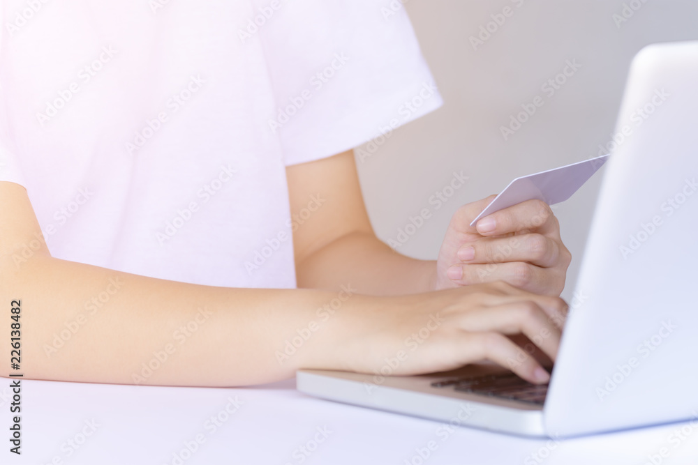 Naklejka premium woman working with credit card on laptop