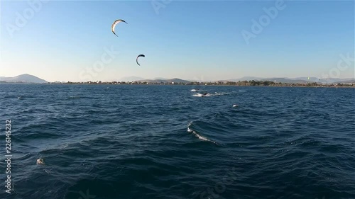 Two Kite Surfers Jumps on Opened Sea. Slow Motion. Gimbal Stabilized 4K. Two young men kitesurfing in the blue ocean in slowmotion. Jumping and having fun outside in nature. Extreme sports summer. 