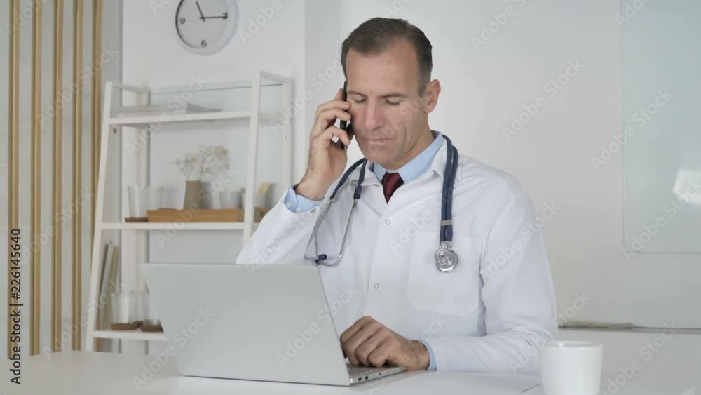 Doctor Attending Phone Call of Patient, Discussing Health Doctor Attending Phone Call of Patient, Discussing Health