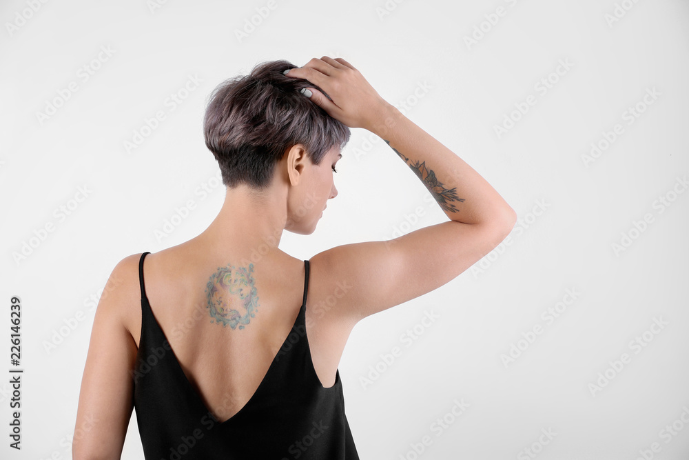 Trendy young woman with tattoos on white background. Space for text Trendy young woman with tattoos on white background. Space for text