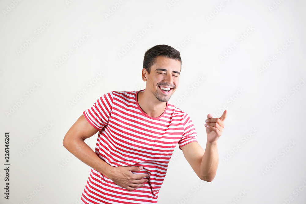 Portrait of handsome young man laughing on white background Portrait of handsome young man laughing on white background