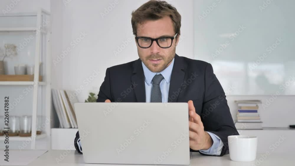 Businessman Reacting to Financial Loss at Work Businessman Reacting to Financial Loss at Work