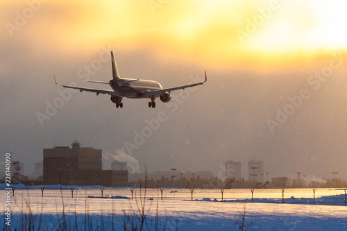 On a snowy winter evening, a jet plane lands at Sheremetyevo Airport in Moscow, Russia
