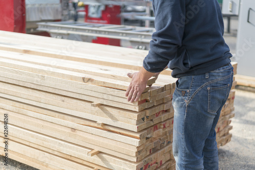 A man works at a sawmill. Man folding boards © jollier_
