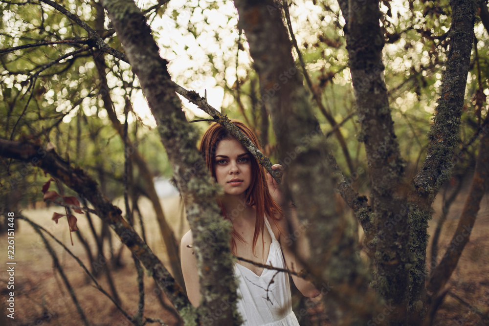woman in the trees in the village garden woman in the trees in the village garden