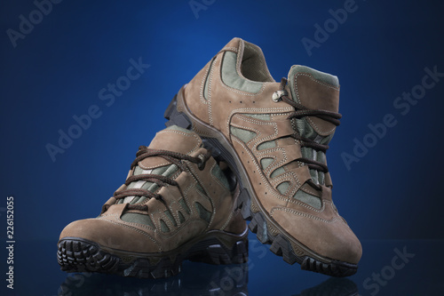 Hiking boots on blue background
