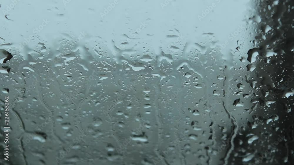 Rain drops of water on the transparent glass of window Rain drops of water on the transparent glass of window
